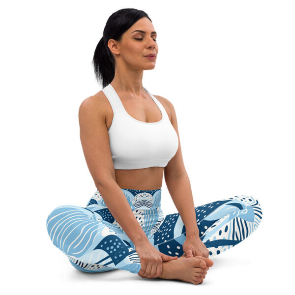 a woman sitting cross legged with her legs crossed wearing pilates leggings